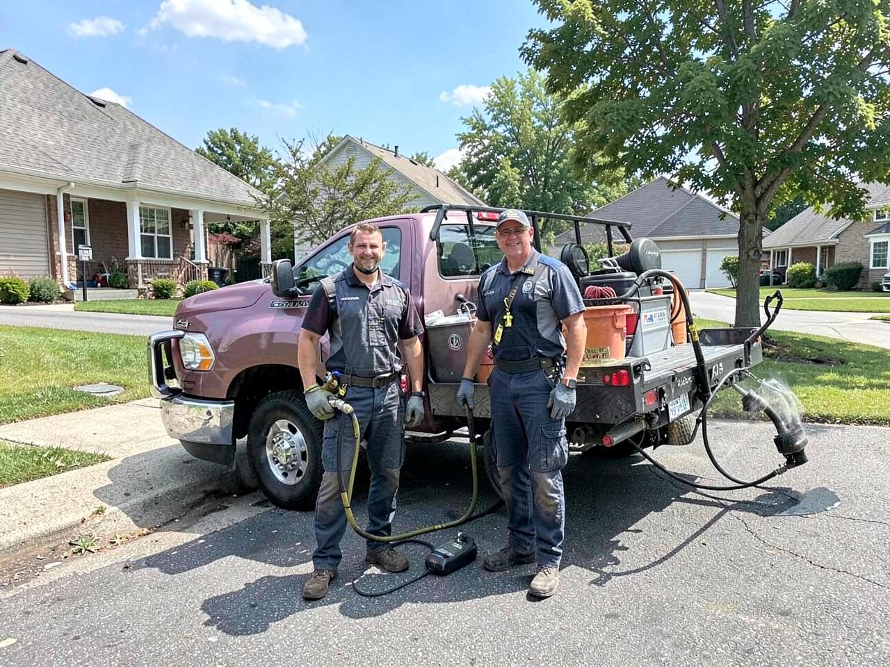 The Summit Blast Exterior Cleaning crew beside their pressure washing truck